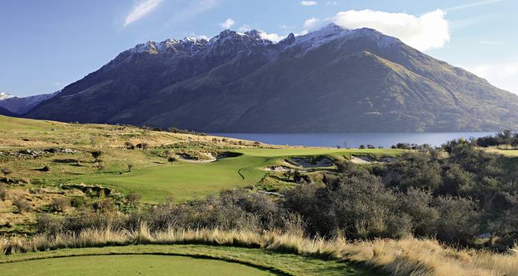 Golf course with a mountainous backdrop.