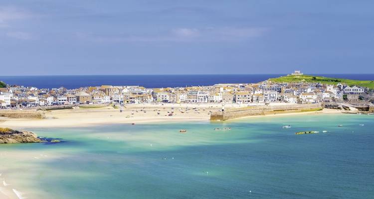 Seaside town with sandy beaches and blue waters.