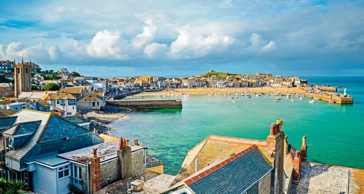 Coastal town with a sandy beach and turquoise water.