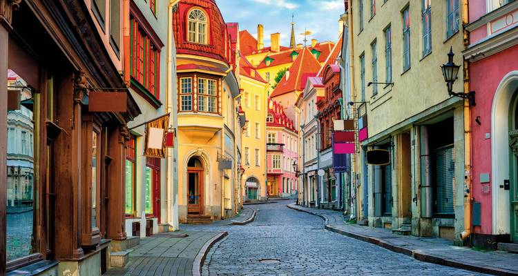 Vibrant street with historical architecture during sunset.