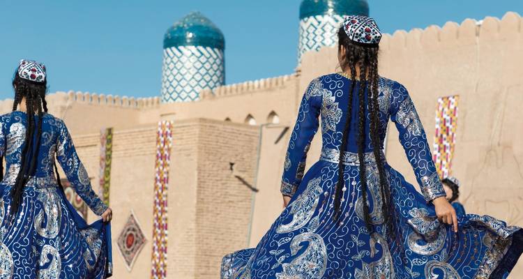 Women in traditional attire performing a cultural dance.
