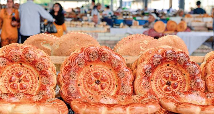Close-up of traditional bread loaves displayed in a market.