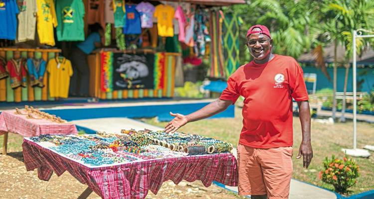 Vendor selling colorful souvenirs at an outdoor market.