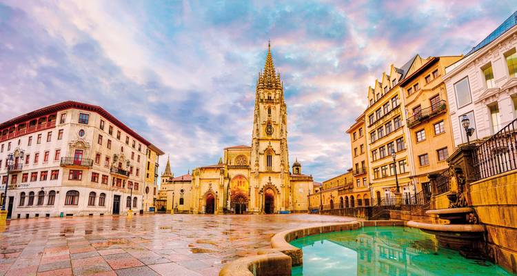 Historical square with ornate church and fountain.