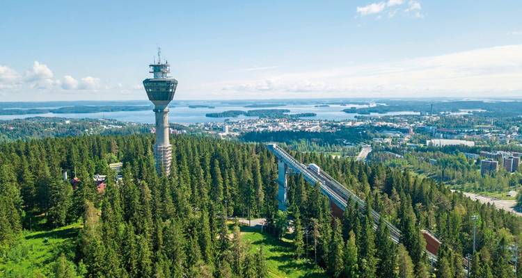 Tower amidst a forest in Kuopio, with extensive views in the background.