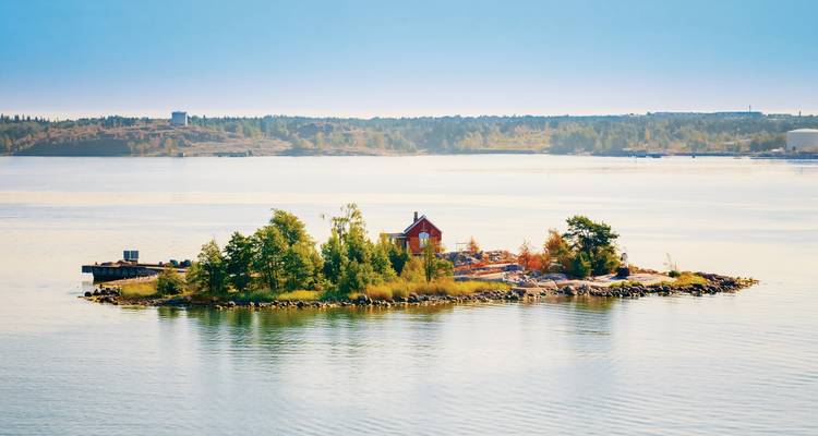 Solitary island with a small building surrounded by water.