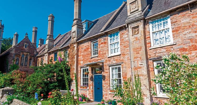 Charmantes chaumières en pierre avec des jardins colorés.