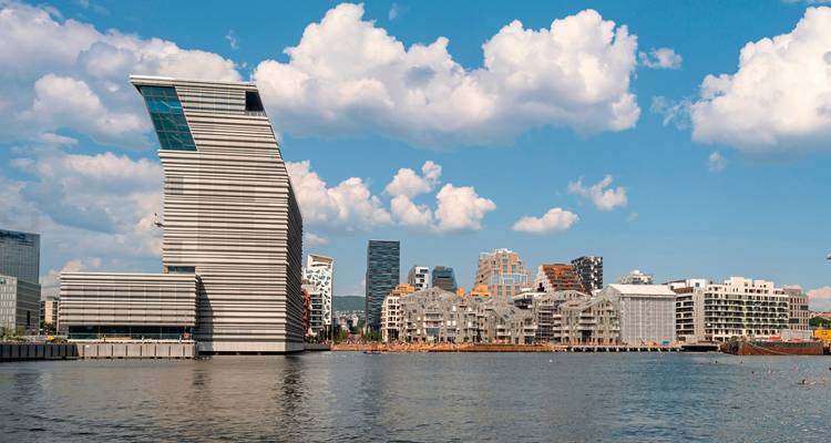 Modern waterfront cityscape with unique architecture.