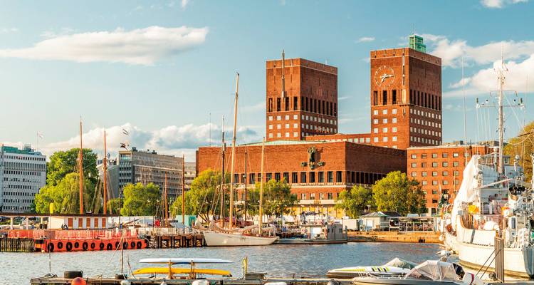 Historic building with clock towers by the water.