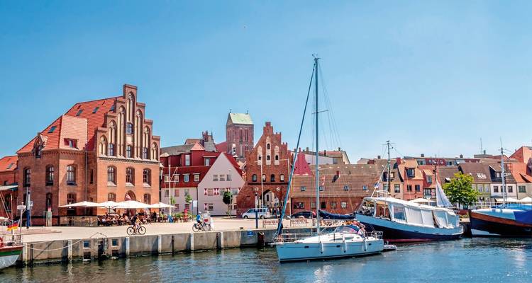 Scenic view of a harbor with historic buildings and boats.