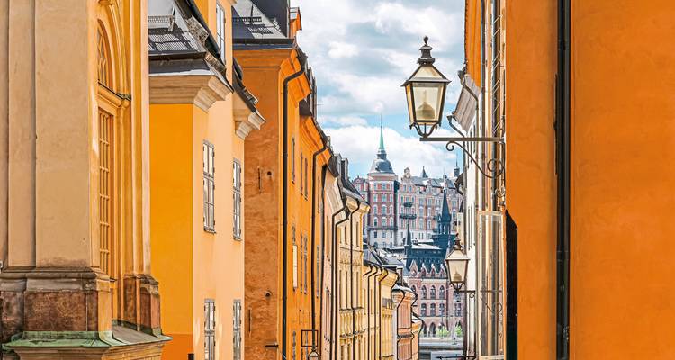 Charming alley with brightly colored buildings and decorative street lights.