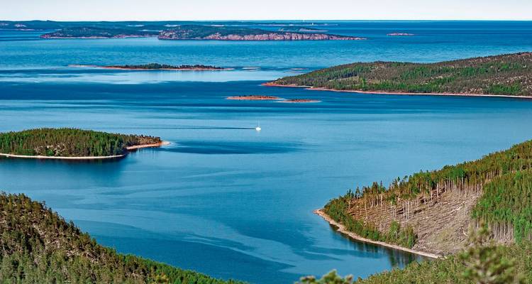 Aerial view of multiple islands with dense forest.
