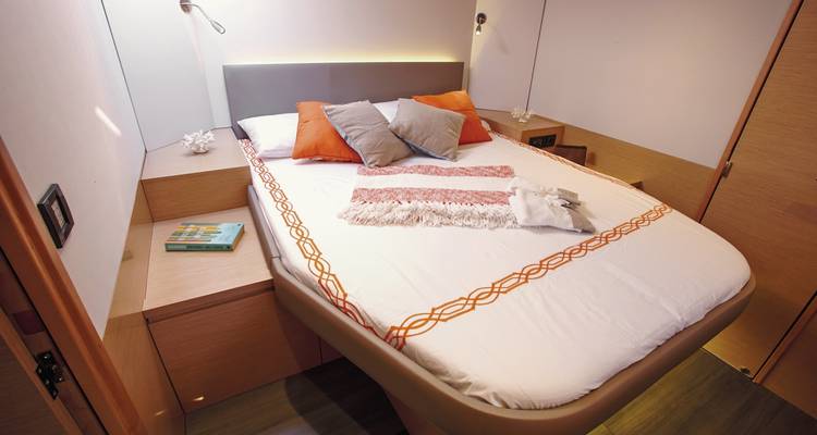 Interior of a cabin with a neatly made bed.