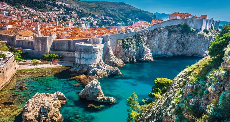 View of Dubrovnik city walls and the rocky coastline.