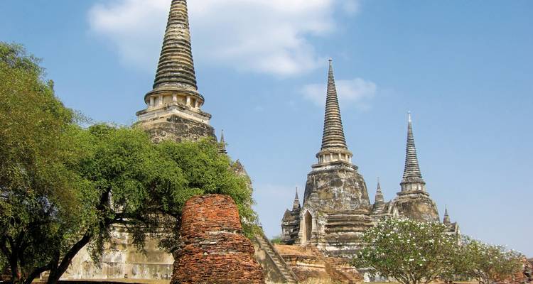 Historic temple with tall spires against a blue sky.