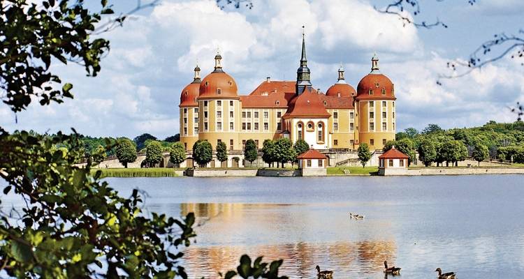 Baroque castle with an expansive lake view.