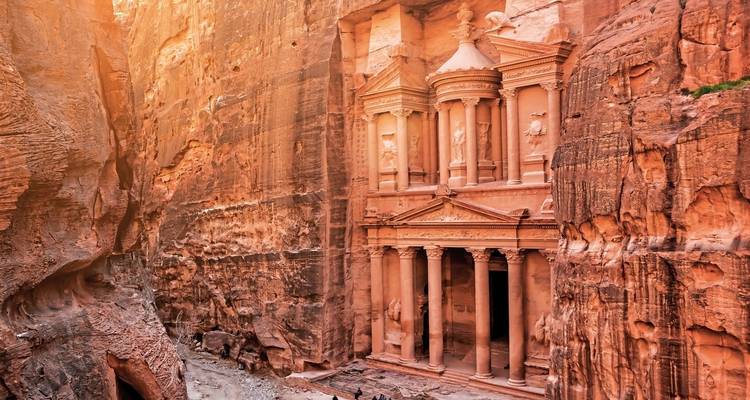The iconic facade of Petra's Treasury carved into red sandstone cliffs.