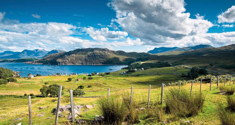Scenic Scottish highland landscape with a loch and mountains.