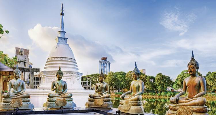 Temple bouddhiste avec plusieurs statues et vue sur le lac.