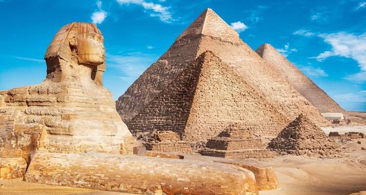 Great Pyramids and Sphinx under a blue sky.