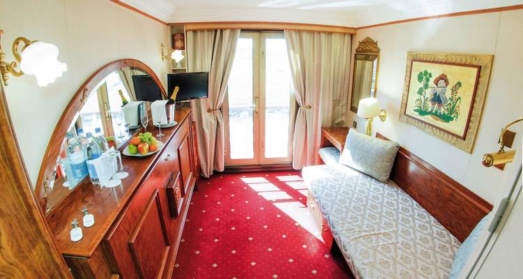 A cozy cruise ship cabin with a decorative style.
