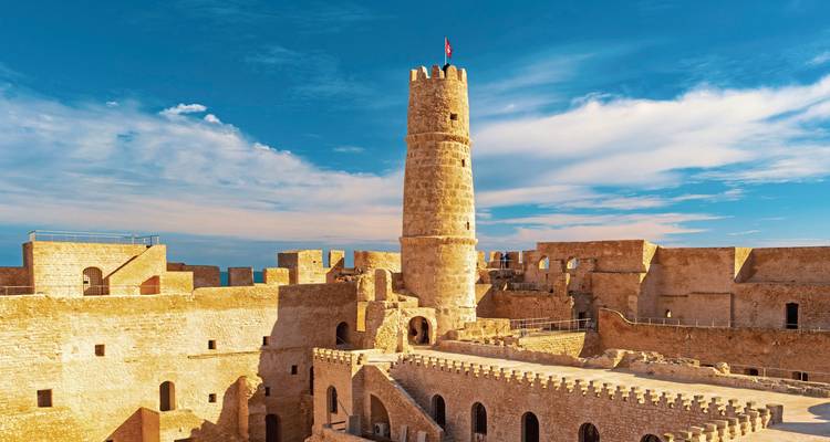 Historic fortress with a prominent tower against a blue sky.