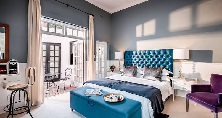 Modern and elegant bedroom with blue accents.