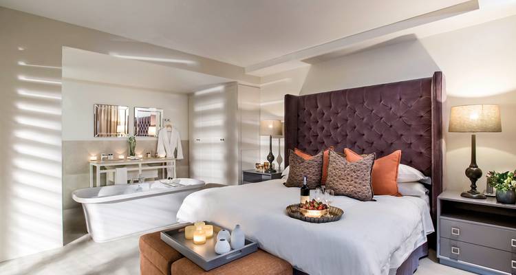 Luxurious bedroom with elegant decor and a bathtub.