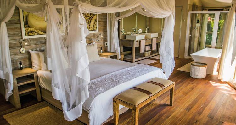 Elegant interior with canopy bed and modern amenities.