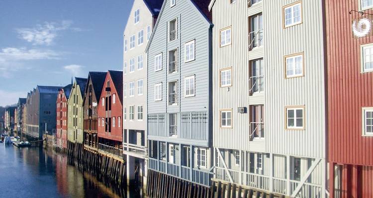 Colorful waterfront buildings on stilts along a canal.