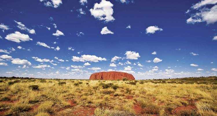 Remote desert landscape with a large red rock formation