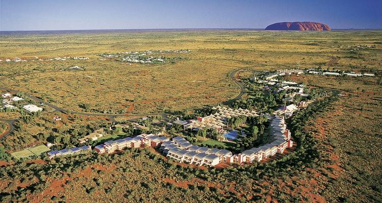 Aerial view of a resort near a red rock formation