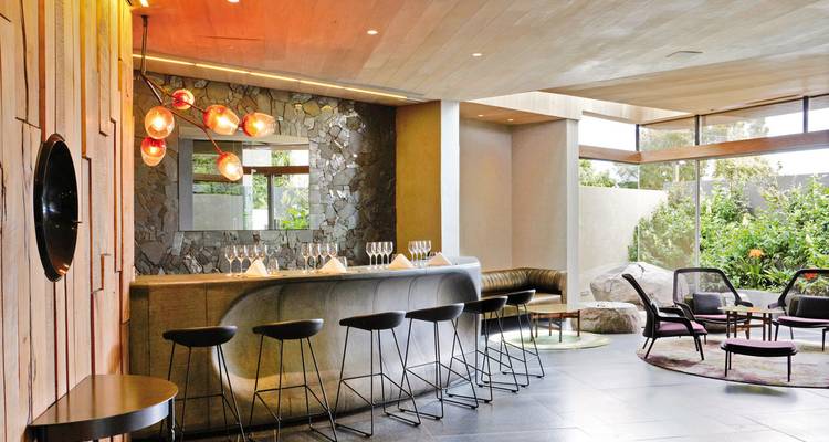 Stylish bar interior with eclectic furniture and lighting.