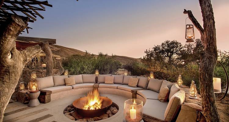 Circular seating area around a fire pit, surrounded by rustic decor.