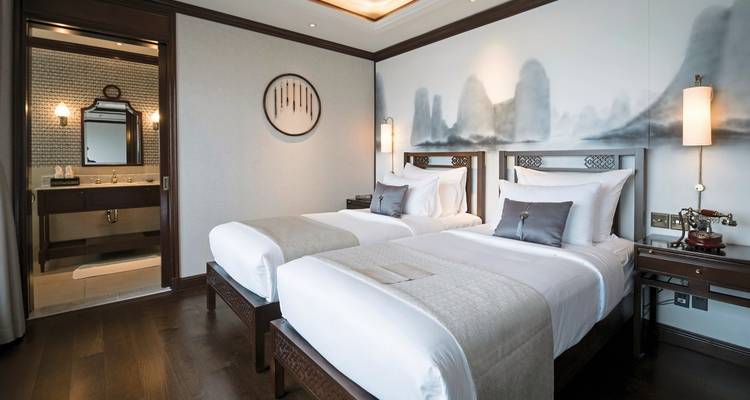 Twin bed hotel room with artistic decor