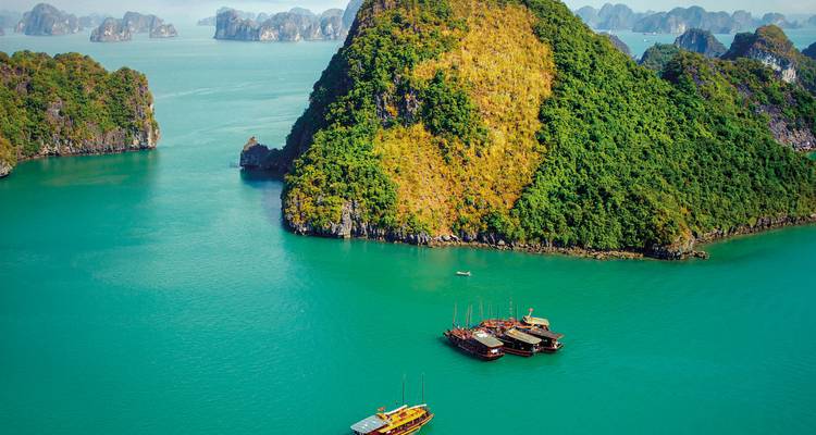 Halong Bay with traditional boats and limestone karsts