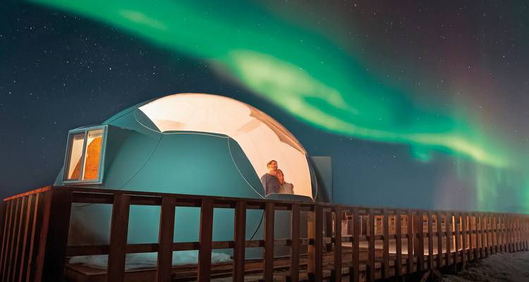 Dome with Northern Lights in the background.