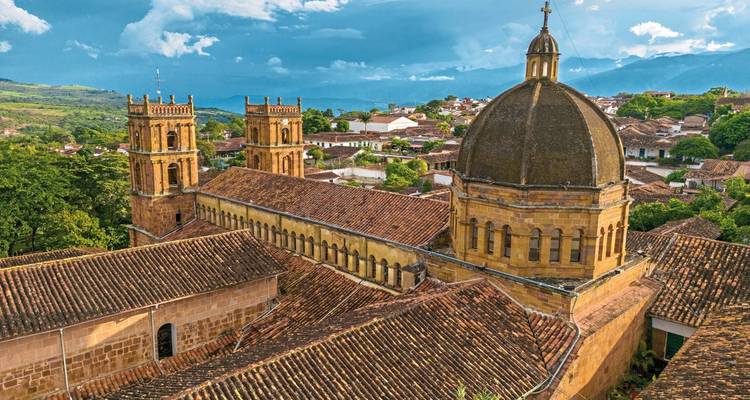 Historic yellow dome and towers in a cityscape.