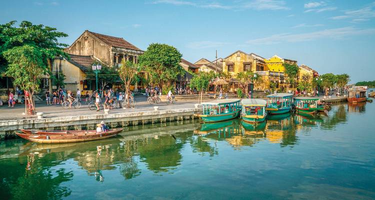 Quaint riverside scene in Hoi An with boats and ancient houses