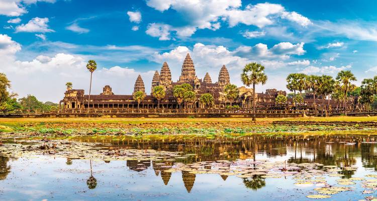 Panoramic view of Angkor Wat with lotus-filled reflecting pond.