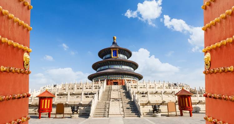 Temple of Heaven in Beijing framed by open red doors.