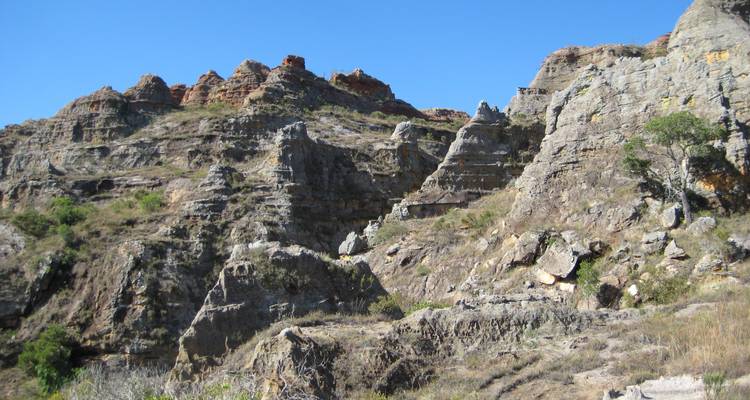 Rocky geological formation under a clear blue sky.