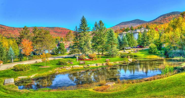 Scenic park with pond and autumn foliage in North Conway, USA.