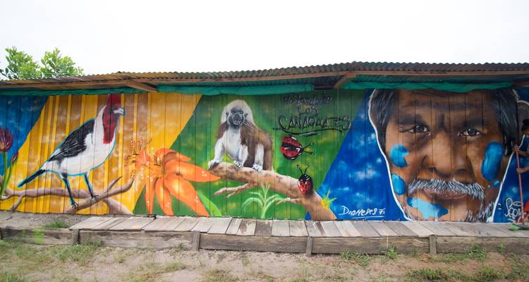 A colorful mural with wildlife painted on a wall.