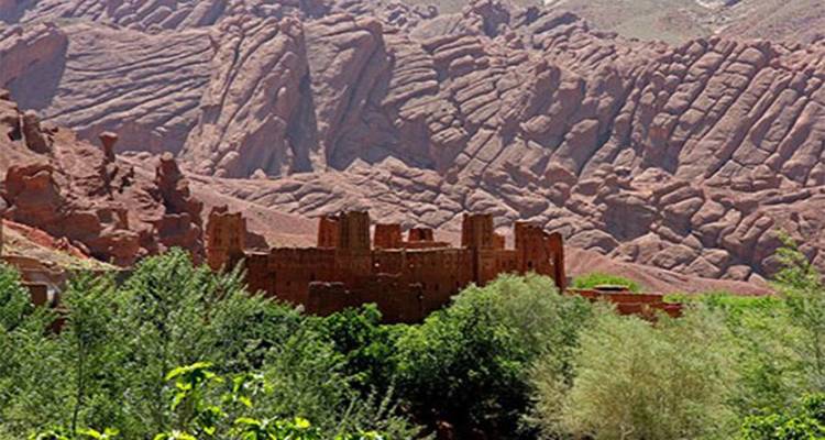 Alte Festungsanlage vor einer felsigen Berglandschaft.