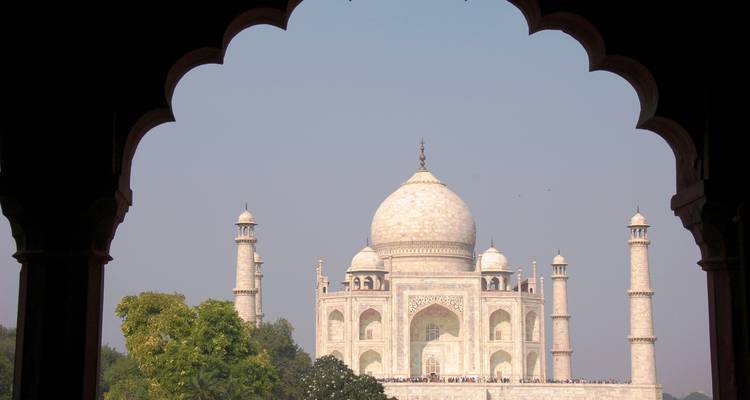 A view of the Taj Mahal through an arched doorway.