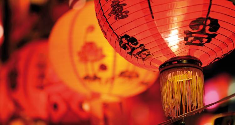 Close-up of traditional red lanterns with Japanese characters.