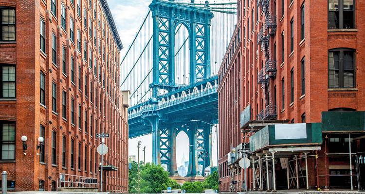 View of the Manhattan Bridge framed by buildings in Dumbo, Brooklyn.