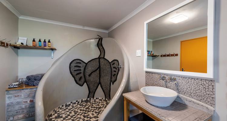 A modern bathroom featuring a unique elephant-themed decor.