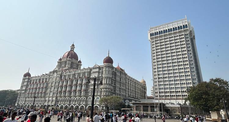 The Taj Mahal Palace Hotel next to a modern high-rise building.